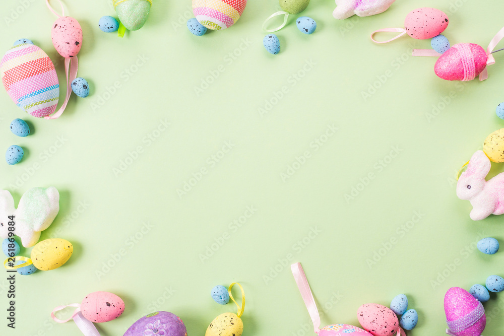 Easter colorful decor flat lay frame on green pastel background. Spring colors