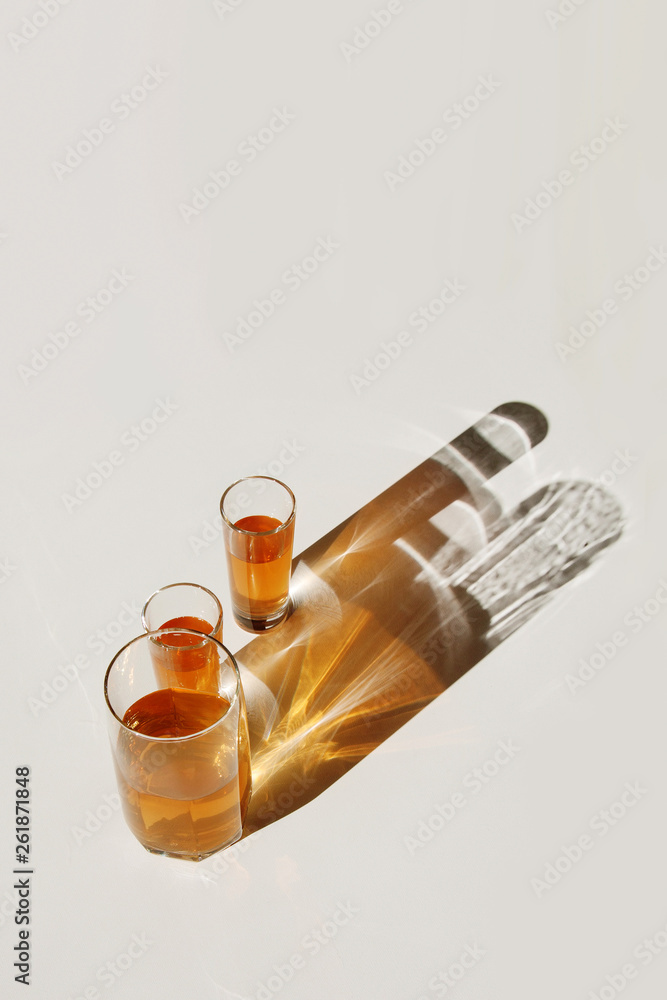 Fototapeta premium Glasses with drink. Colored shadows.