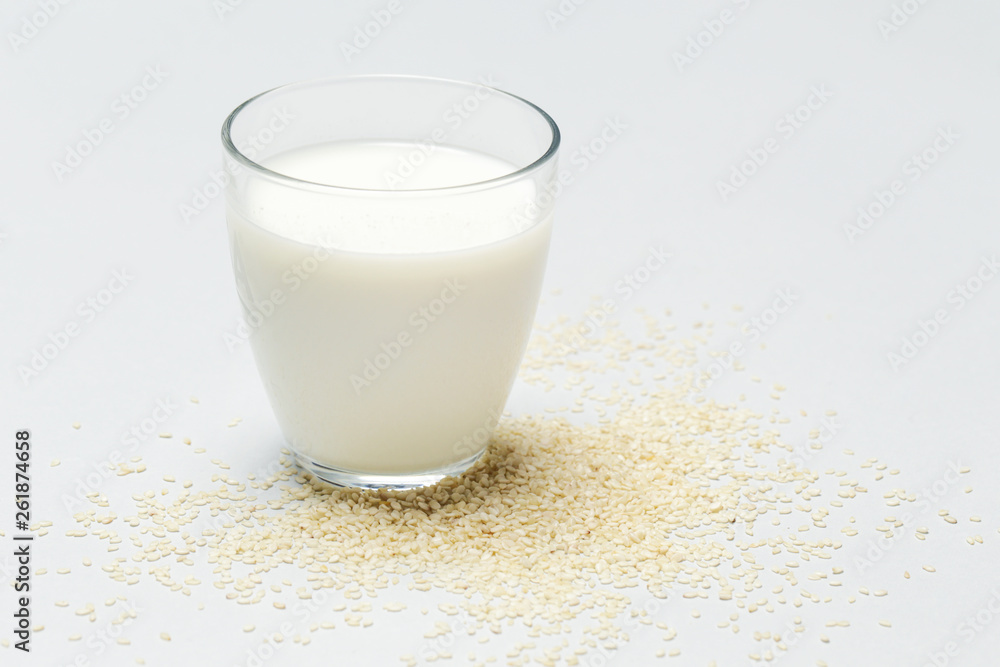 Sesame milk and seeds. Organic vegan non-dairy plant-based milk in a glass. Sesame milk and seeds. Organic vegan non-dairy plant-based milk in a glass.