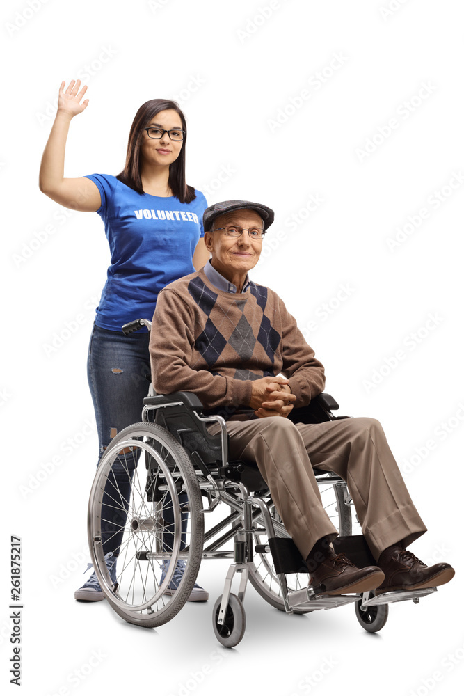 Young woman volunteer pushing a senior man in a wheelchair and showing thumbs up Young woman volunteer pushing a senior man in a wheelchair and showing thumbs up