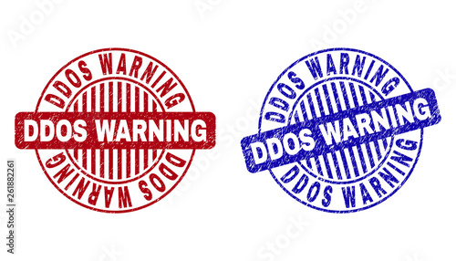 Grunge DDOS WARNING round stamp seals isolated on a white background. Round seals with distress texture in red and blue colors.