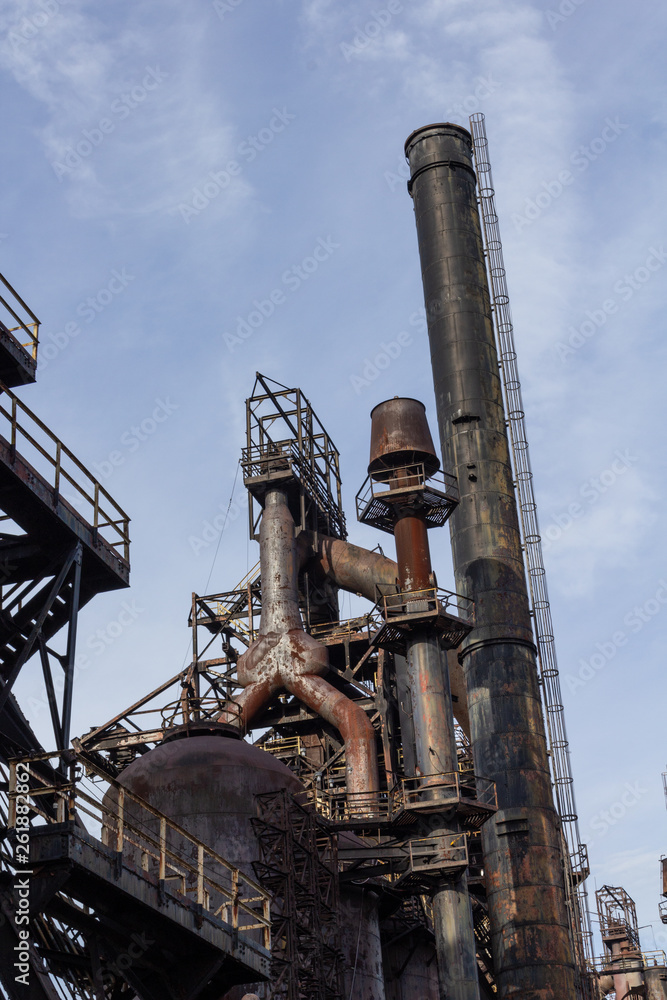 Smokestack and blast furnace, steel industry complex, industrial textures, vertical aspect Smokestack and blast furnace, steel industry complex, industrial textures, vertical aspect