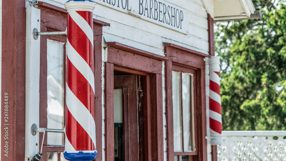 An historic barber shop put on display in an historic town in North East Ohio. A barber's pole is a type of sign used by barbers to signify the place or shop where they perform their craft. An historic barber shop put on display in an historic town in North East Ohio. A barber's pole is a type of sign used by barbers to signify the place or shop where they perform their craft.