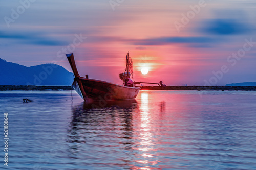 small fishing boat in sea during sunrise photo