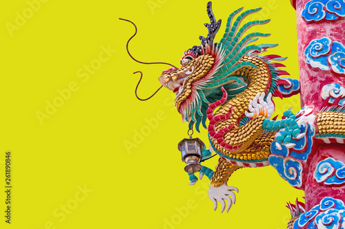 Chinese style dragon statue on yellow background. © pittawut