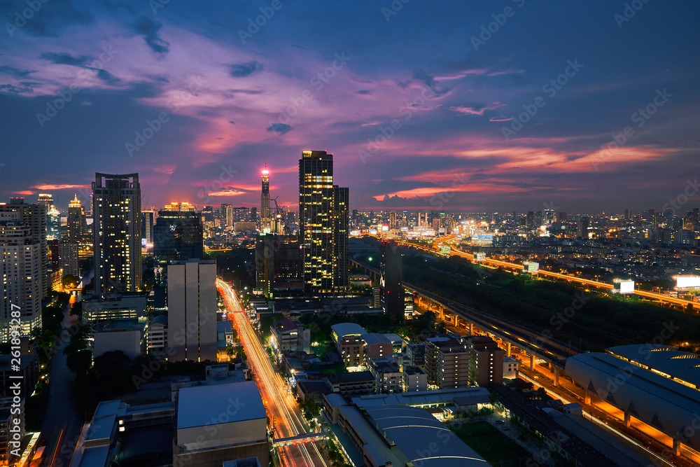 sunset skyline with cityscape metropolis lighting up