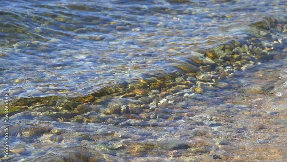 Clean transparent water wave surfing on the sand shore with slow motion in Baikal lake Olkhon island, Irkutsk Russia Clean transparent water wave surfing on the sand shore with slow motion in Baikal lake Olkhon island, Irkutsk Russia