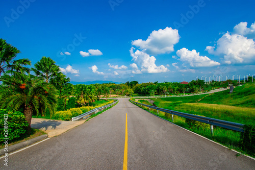 street view with green mountain on blue sky background in the province of Thailand. decoration image contain certain grain noise and soft focus.