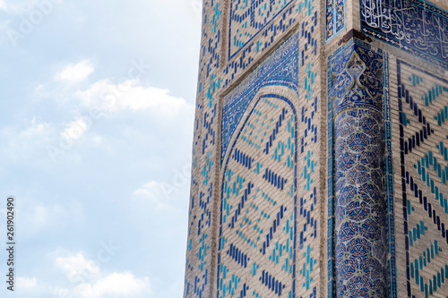 Traditional Islamic ornament details. Uzbek Architecture. Details of ancient walls of building with handmade ornament tiles in Bukhara, Uzbekistan