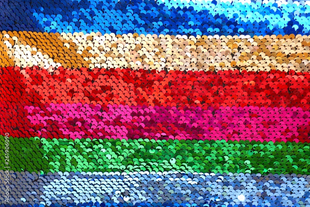 Obraz premium Sequins background.sequins striped fabric.Texture scales with Sequins close-up.Sequins multicolored stripe.Shiny texture sequin material