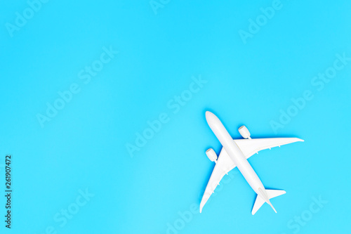 Model plane, airplane on blue pastel color background with copy space.Flat lay design.Travel concept on blue background. top view model plane on blue color background. © zoneteen