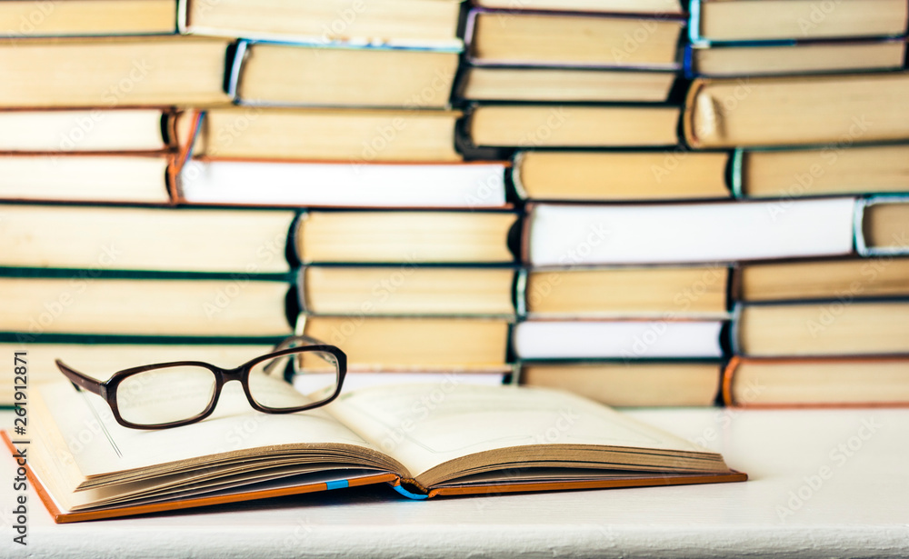 Books background, open book and glasses on white wooden table in office business background for education learning concept. Books background, open book and glasses on white wooden table in office business background for education learning concept.