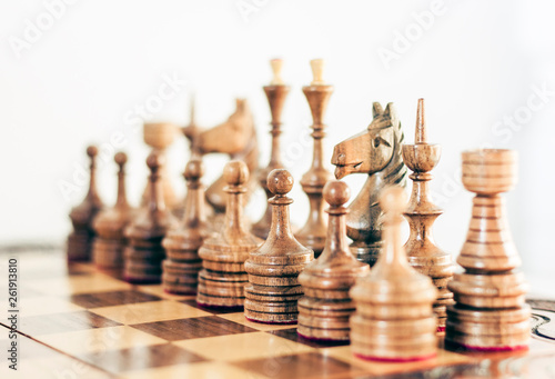 Wooden chess pieces on a chessboard  leadership concept on white background.