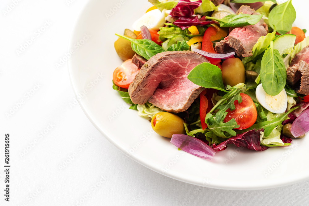 Thai grilled beef salad on the white plate Thai grilled beef salad on the white plate