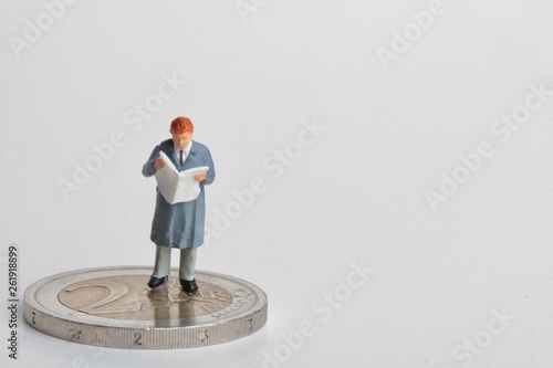 miniature of people reading and euro coins