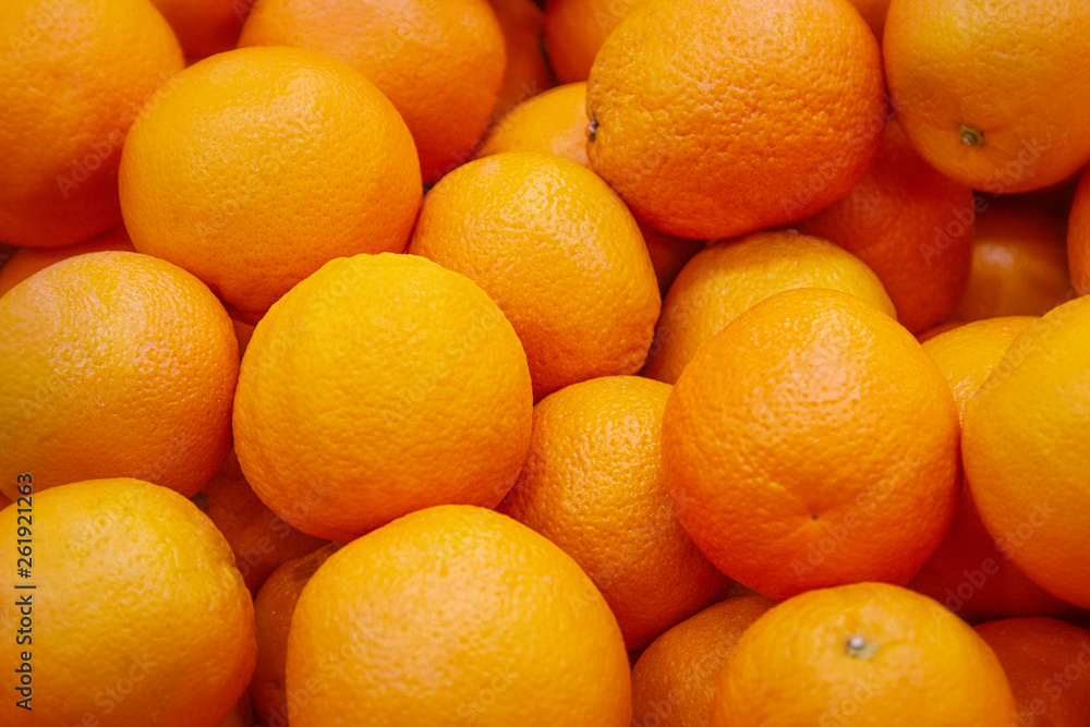 Fresh mandarin oranges texture. Fresh oranges lying on the counter - orange and tangerine texture with round oranges and tangerines Fresh mandarin oranges texture. Fresh oranges lying on the counter - orange and tangerine texture with round oranges and tangerines