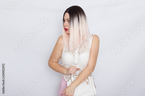 Blonde woman with white handbag