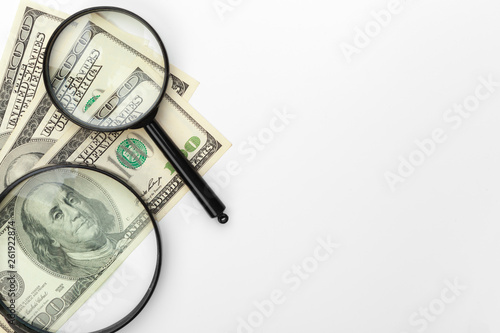 Magnifying glass and a pile of money.
