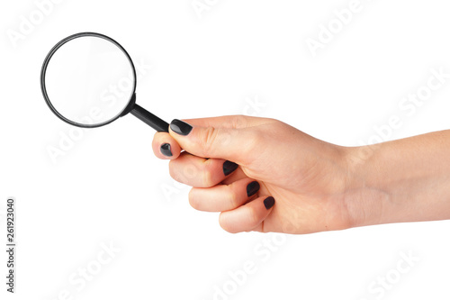 Magnifying glass in a woman hand isolated on white background