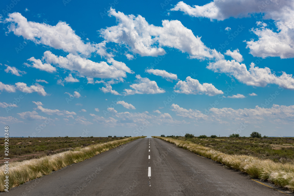 vibrant image of desert road and blue cloudy sky vibrant image of desert road and blue cloudy sky