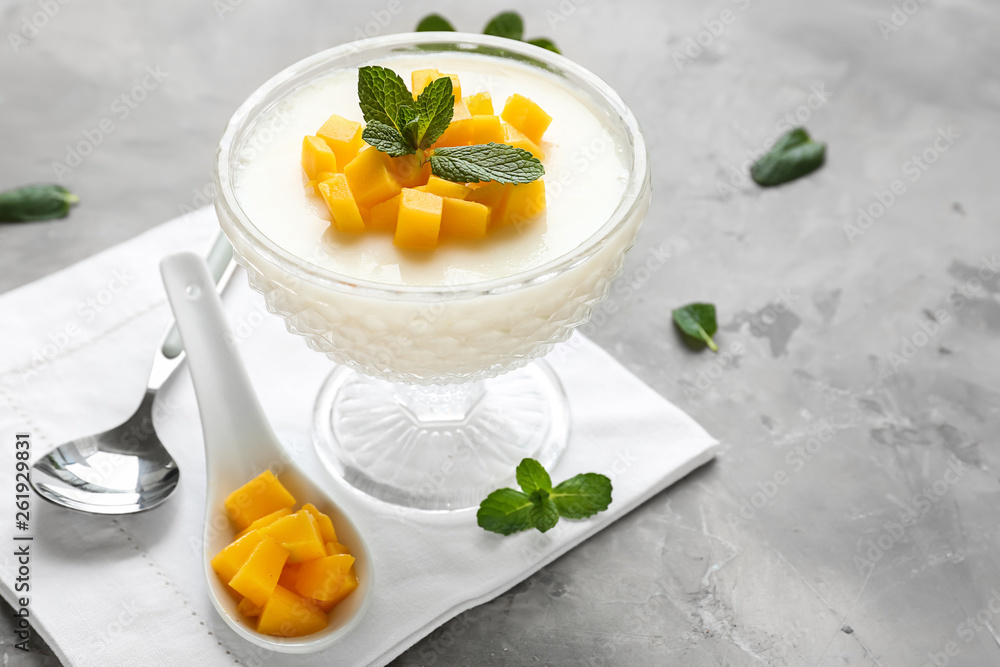 Bowl of delicious panna cotta on grey table Bowl of delicious panna cotta on grey table