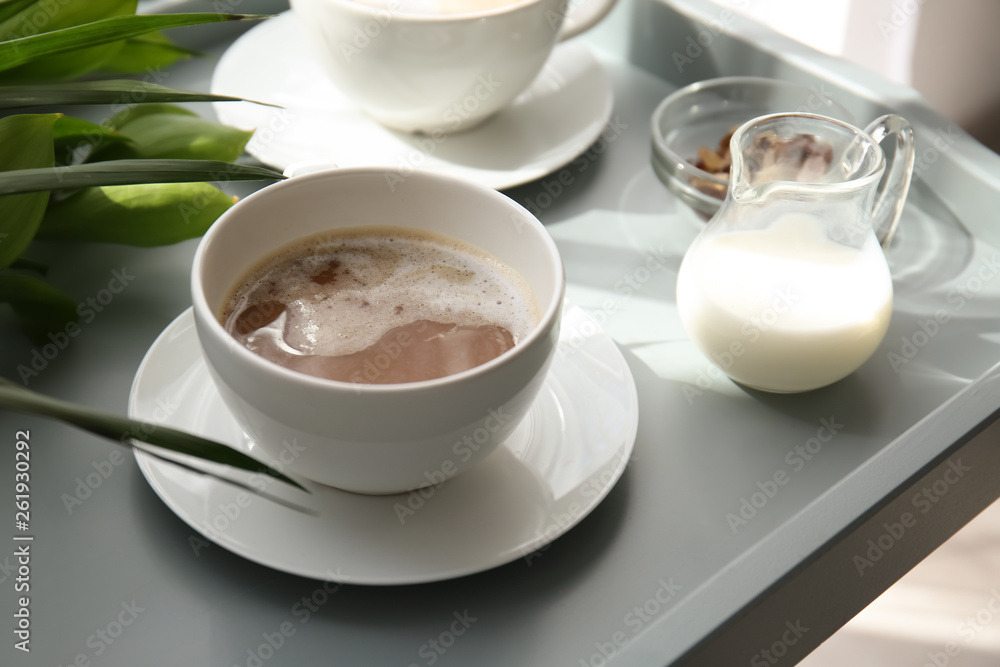Cup of tasty frappe coffee and milk on tray Cup of tasty frappe coffee and milk on tray