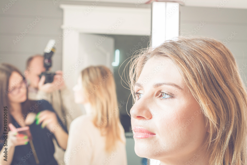Fototapeta premium young, beautiful blonde woman put on make-up in a beauty salon, fashion concept