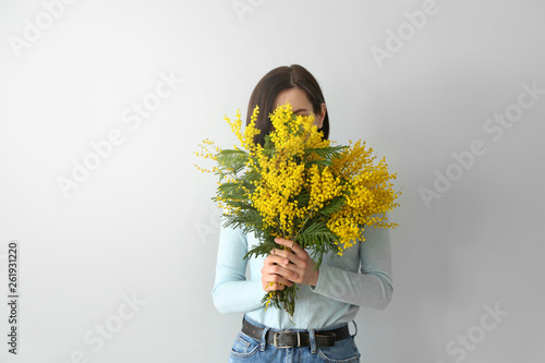 Young woman holding bouquet...