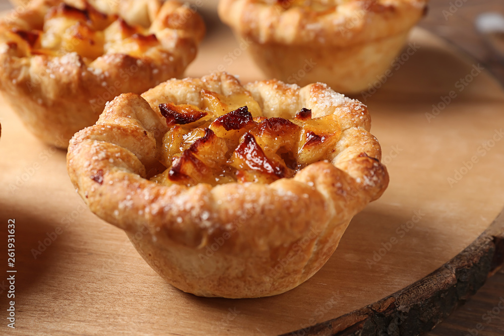 Tasty apple pies on wooden board, closeup Tasty apple pies on wooden board, closeup