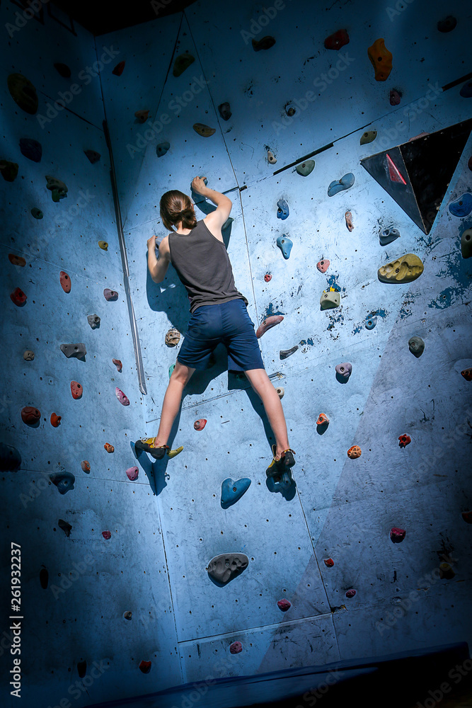 Teenage Boy Training On Climbing Wall Teenage Boy Training On Climbing Wall