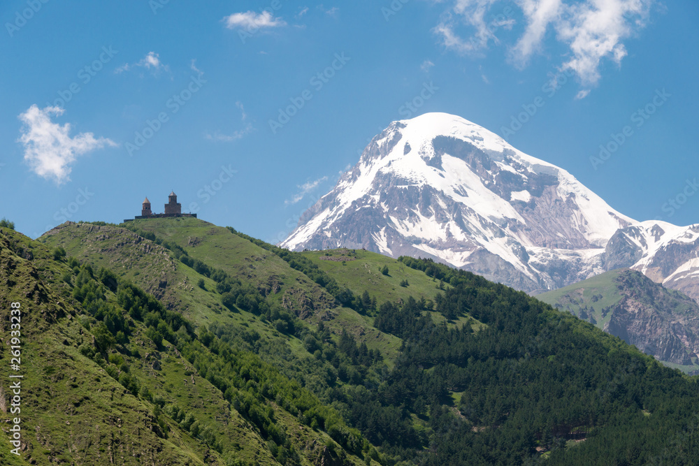 Kazbegi, Georgia - Jun 30 2018: Mount Kazbek at Gergeti Trinity Church. a famous landscape in Kazbegi, Mtskheta-Mtianeti, Georgia.