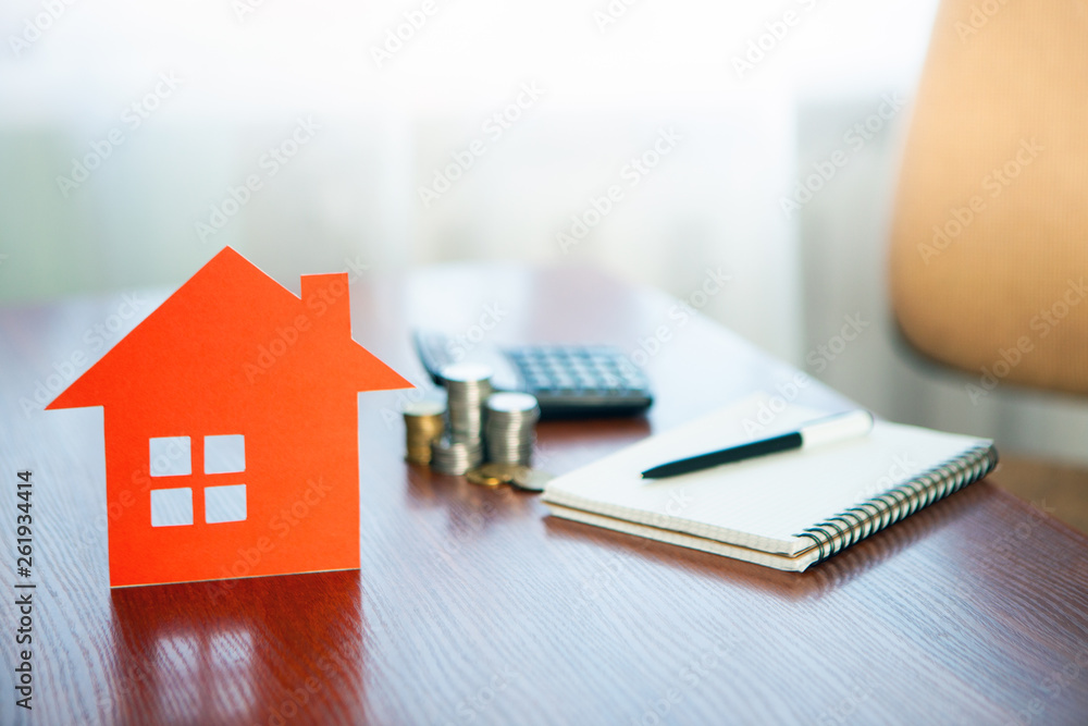 Buying and selling houses and real estate prices. Concept. Man using calculator to count rent money. Buying and selling houses and real estate prices. Concept. Man using calculator to count rent money.