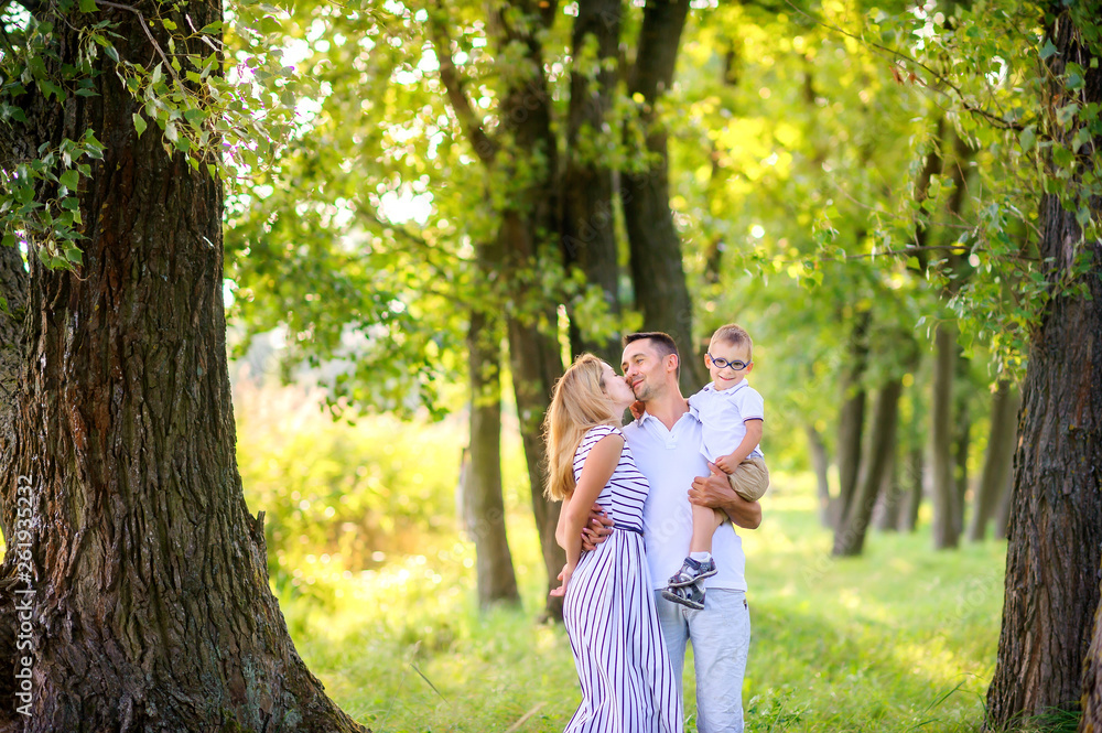 Loving family. Happy young family spending time together having fun in summer park, people concept. Family еnjoying time together