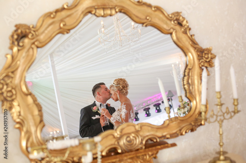Beautiful wedding couple posing in mirror