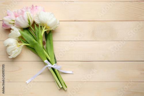 Beautiful tulip flowers on wooden background