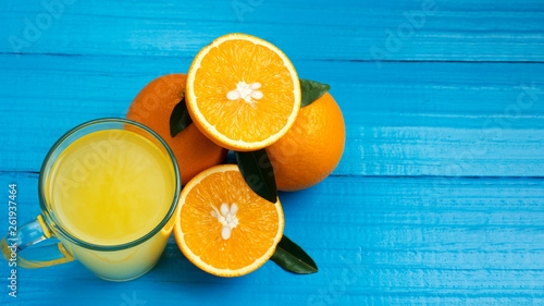 Freshly squeezed orange juice in the glass. Cut ripe oranges