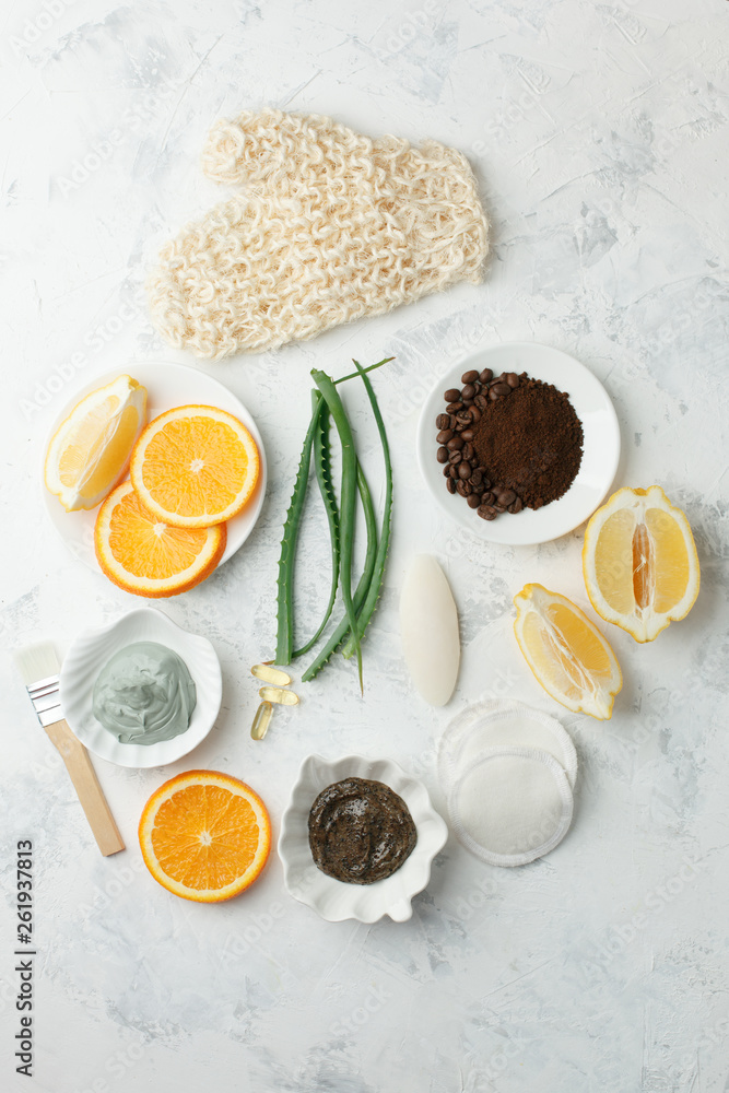 Homemade skin care and body scrub and mask with natural ingredients honey, lemon, clay, coffee grain, aloe vera, oranges set up on white background Homemade skin care and body scrub and mask with natural ingredients honey, lemon, clay, coffee grain, aloe vera, oranges set up on white background