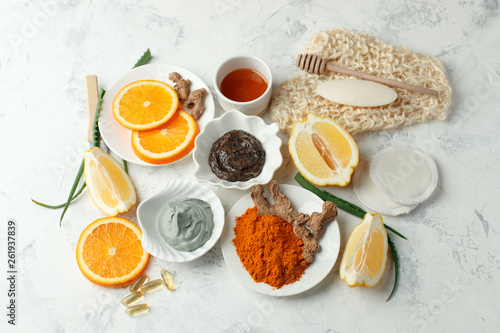 Homemade skin care and body scrub and mask with natural ingredients honey, lemon, clay, coffee grain, aloe vera, oranges set up on white background