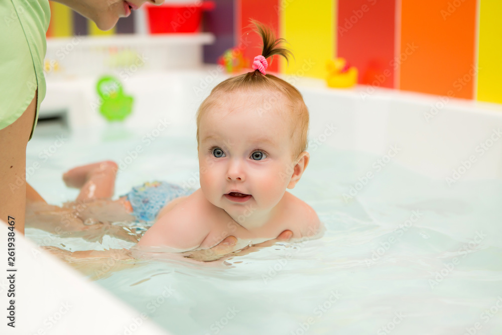 infant swimming,Mother teaching baby to swim in water pool,Little baby's first swim infant swimming,Mother teaching baby to swim in water pool,Little baby's first swim