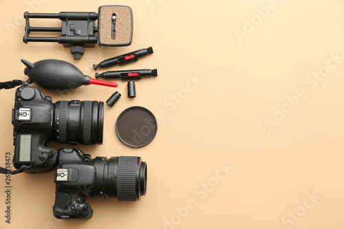 Modern equipment of professional photographer on color background