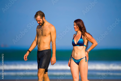 happy and beautiful couple enjoying Summer holidays travel or honeymoon trip together in tropical paradise beach having fun relaxed and playful on the sea