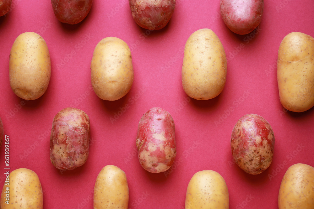 Raw potatoes on color background Raw potatoes on color background
