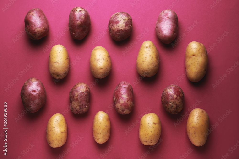 Raw potatoes on color background Raw potatoes on color background
