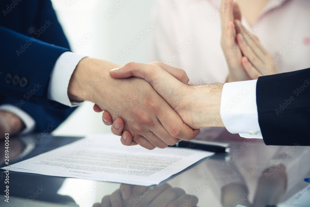 Business people shaking hands finishing up a meeting. Handshake at successful negotiation Business people shaking hands finishing up a meeting. Handshake at successful negotiation