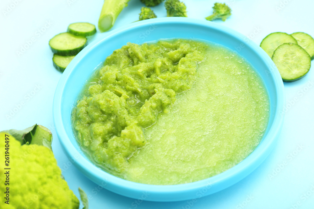 Plate with healthy baby food on color background Plate with healthy baby food on color background