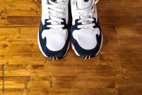 sneakers on old retro wooden background.