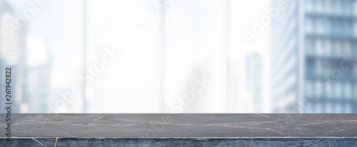 Empty black marble stone table top and blur glass window wall building banner mock up background - can used for display or montage your products. photo