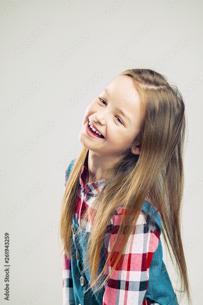 portrait of a happy child. little girl smiles and shows emotion. studio fashion kid shooting. portrait of a happy child. little girl smiles and shows emotion. studio fashion kid shooting.