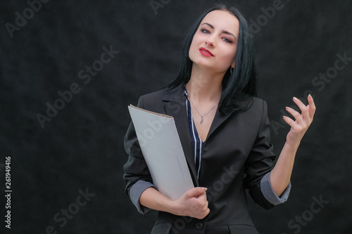Concept Portrait of smiling business brunette Young woman with folder, isolated on colored background. Female model looking at you.