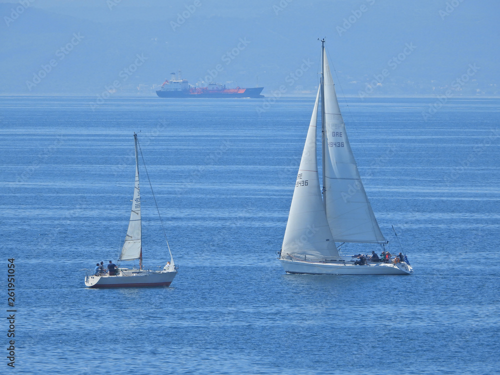 Zoom photo of sail boat sailing the Aegean deep blue sea